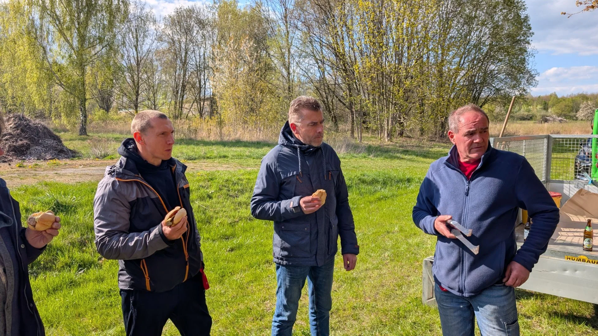Bild: Männliche Lehrkräfte unterhalten sich angeregt im Halbkreis stehend.