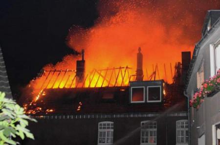 Flammen schlagen aus dem Dachstuhl des Reihenhauses(Quelle: Miklos Laubert www.bf-koeln-einsaetze.de)