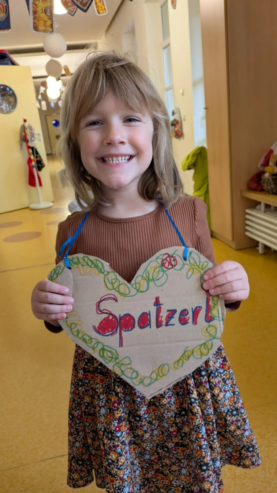 1 Mädchen mit einem Herz um dem Hals, auf dem steht ... Spatzerl
