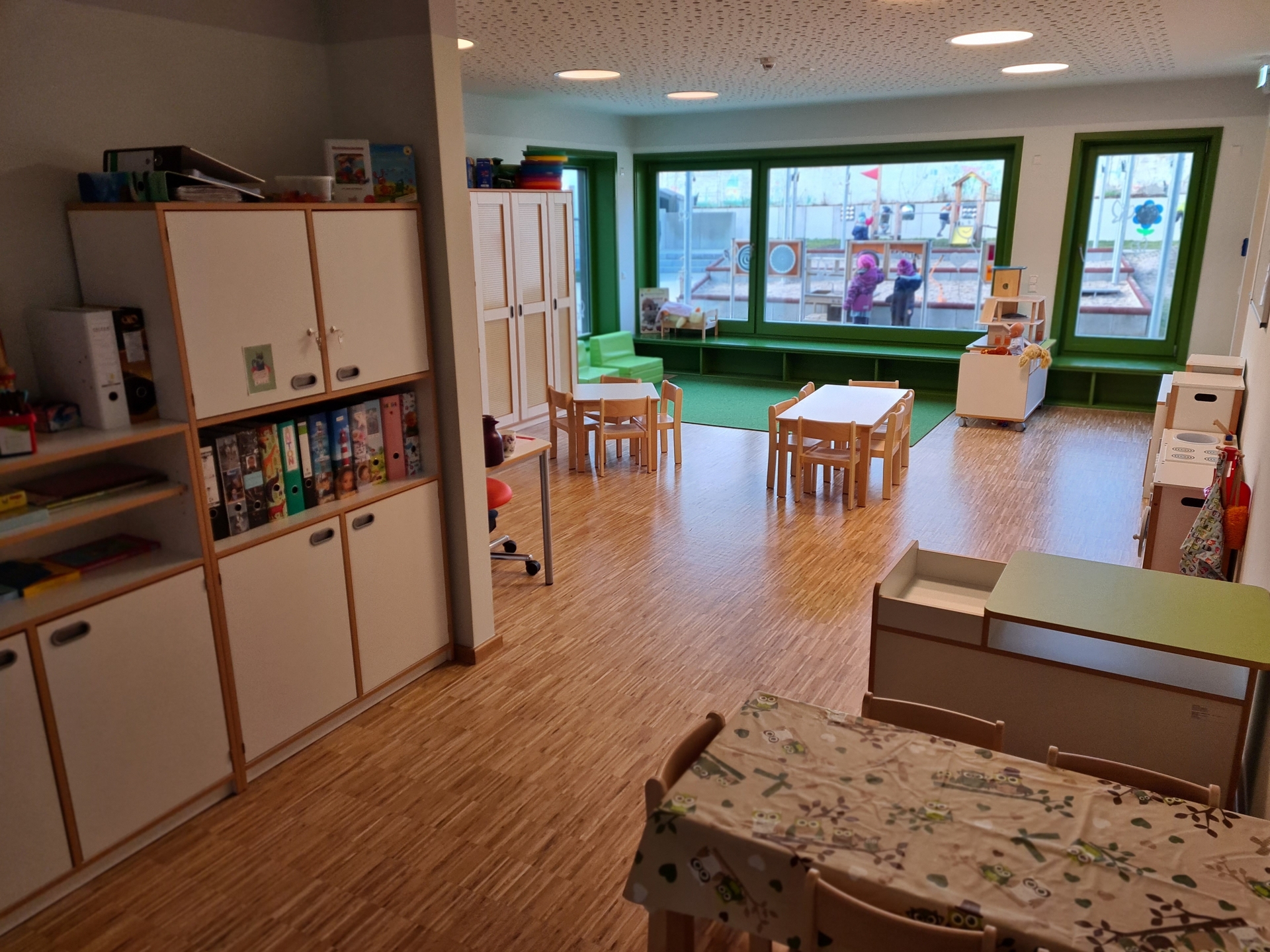 Bild: Gruppenraum mit Spielecke und Blick auf den Spielplatz