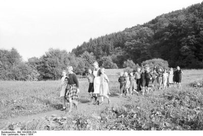 Gruppe von Menschen spaziert auf einem Feldweg (Bild vergrößern)