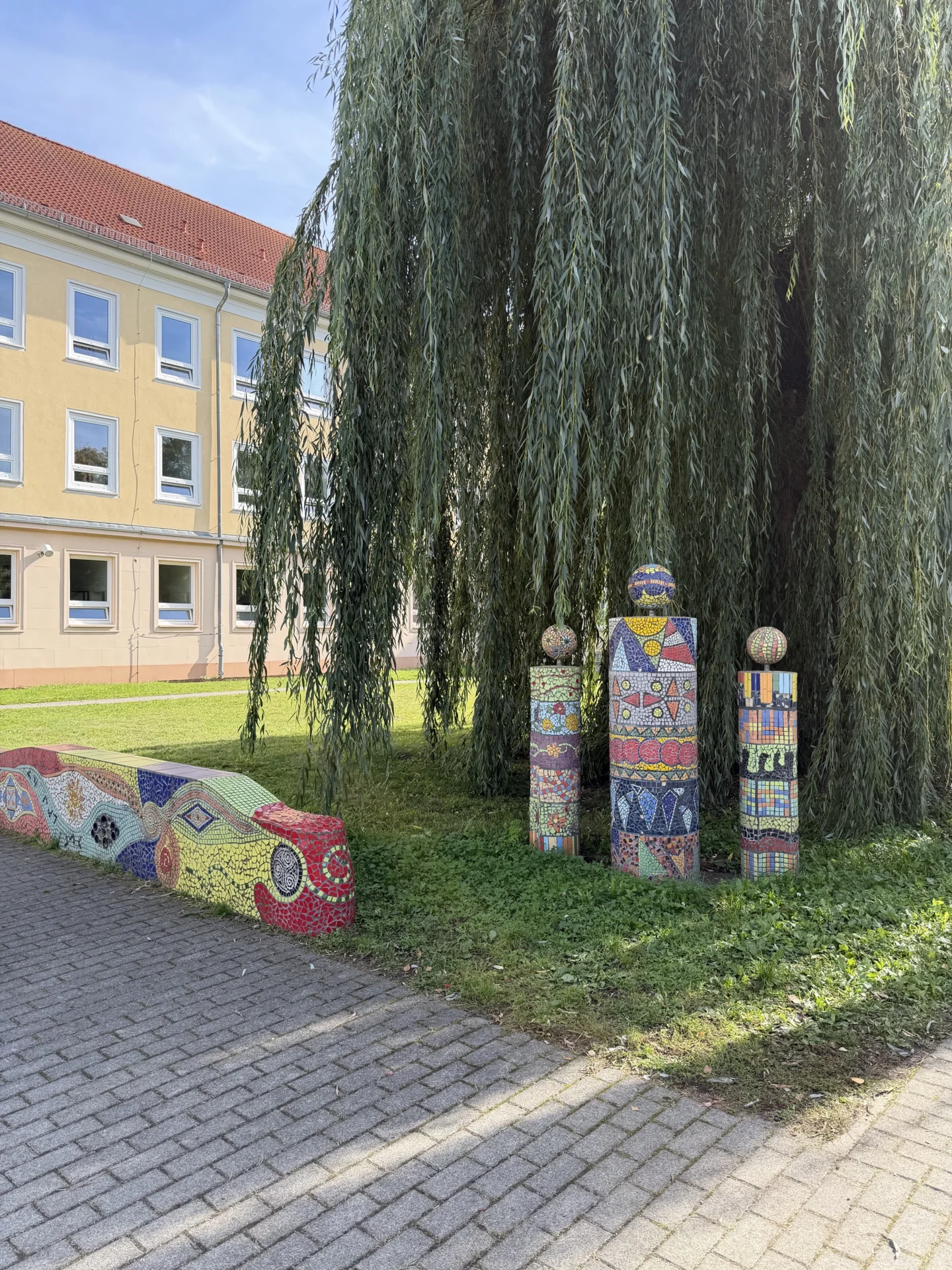 Gro&szlig;er, gr&uuml;ner Schulhof mit viel Platz zum Entspannen und Verweilen in den Pausen. 