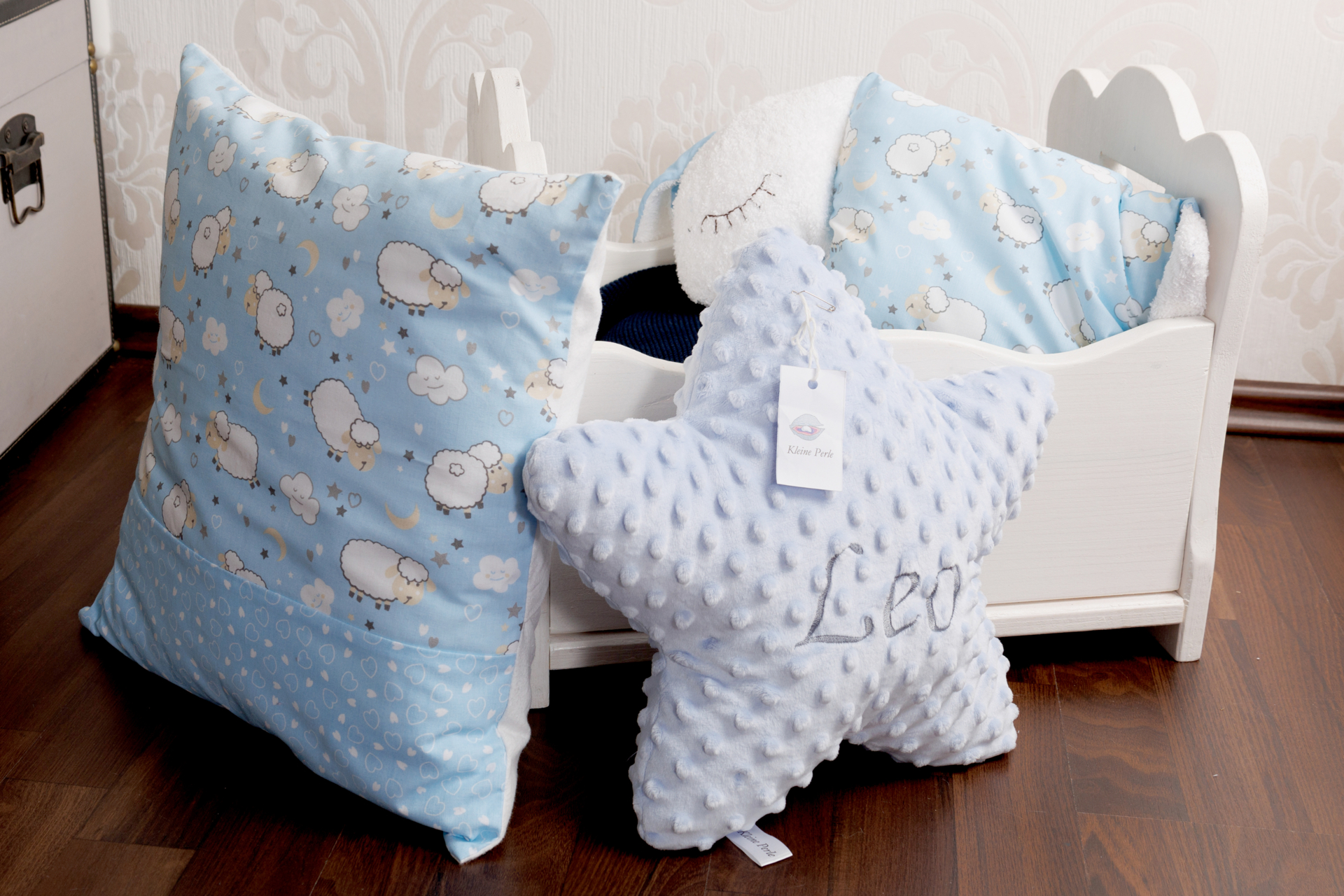 Bild: Kissensortiment |Links: Kissenhülle 40 x 40 cm aus bedrucktem Baumwollstoff, hier mit Schäfchen / Mitte: Fleece-Kissen „Stern“ aus 100 % Polyester, verschiedene Farben möglich, auf Wunsch bestickt, auch als Set mit kleinem Mond und Wolke erhältlich / Rechts: „Schäfchen-Kissen“ aus bedrucktem Baumwollstoff, Kopf und Füße wahlweise aus Frottee oder Molton