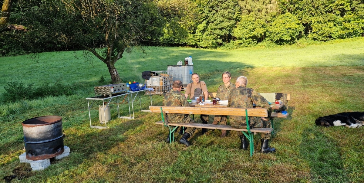 Bild zeigt Soldaten beim Frühstück auf einer Wiese