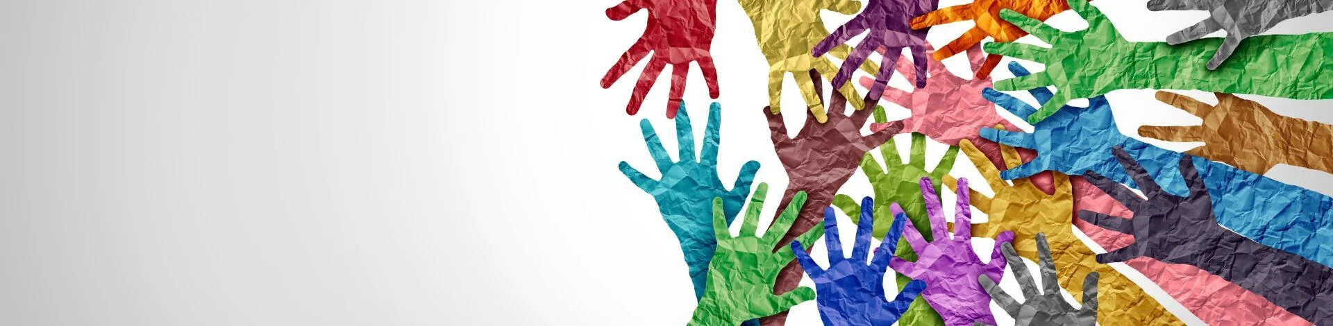 Das Bild zeigt Arme mit Händen aus Papier in unterschiedlichen Farben, die sich in der Mitte treffen. | zur Startseite