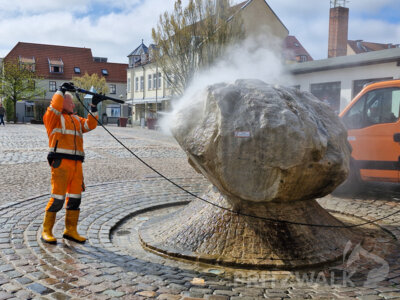 Mitarbeiter des städtischen Bauhofes reinigten am Donnerstag den Brunnenstein auf dem Pritzwalker Marktplatz. Foto: Stadt Pritzwalk (Bild vergrößern)