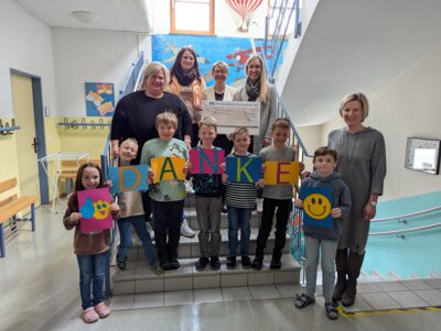 Bei der Spendenübergabe: Melanie Schießl, eine der Leiterinnen der Mittagsbetreuung der Prackenbacher Grundschule (hi.v.l.), die drei Organisatorinnen des Kinderbasars, Martina Gierl, Manuela Fleischmann und Manuela Eckl, sowie Rektorin Katrin Hartl (r.) mit einigen der Kinder.