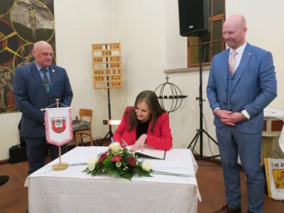 Foto: Botschafterin Magdalena Atria beim Eintrag ins Goldene Buch der Stadt Calau. Hinter ihr im Bild: Knut Jende (links), Vorsitzender der Stadtverordnetenversammlung und Bürgermeister Marco Babenz. Foto: Stadt Calau / Jan Hornhauer Foto zur Meldung: Goldenes Buch der Stadt Calau ist um zwei Einträge reicher