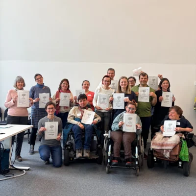 Viele Menschen sind auf dem Bild, sie halten Urkunden aus dem Raum der Würdigung hoch. Die Menschen lachen alle. (Bild vergr&ouml;&szlig;ern)