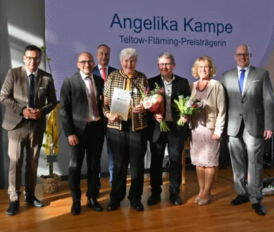 Foto: Angelika Kampe (4.v.l) mit Michael Grunst (Erster Beigeordneter und Leiter Dezernat II), Dr. Johannes Wagner (Staatssekretär für Arbeit, Soziales, Gesundheit und gesellschaftlichen Zusammenhalt), Andreas Schulz (Vorsitzender des Vorstands der Mittelbrandenburgischen Sparkasse Potsdam), Klaus Rocher (Bürgermeister Rangsdorf), Kornelia Wehlan (Landrätin) und Danny Eichelbaum (Kreistagsvorsitzender) - v. l. n. r. © Landkreis Teltow-Fläming Foto zur Meldung: Teltow-Fläming-Preis für Angelika Kampe
