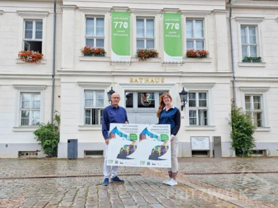 Bürgermeister Dr. Ronald Thiel und Franziska Liebing vom Citybüro präsentieren die Werbeplakate mit QR-Code für die Pritzwalker Herbstlichter am 4. September. Foto: Stadt Pritzwalk (Bild vergr&ouml;&szlig;ern)