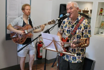Reiner Schlag (re.) an der Gitarre mit Christoball (li.) zur Eröffnung seiner Ausstellung "Streetphotographie Dresden"