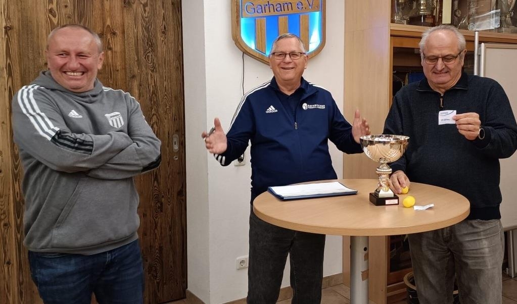 Der ehemalige Spielgruppenleiter Alois Eder (r.) zieht im Beisein des Garhamer Vorsitzenden Josef Leizinger (l.) und Spielleiters Wolfgang Heyne die Halbfinal-Paarungen. − Foto: Verein