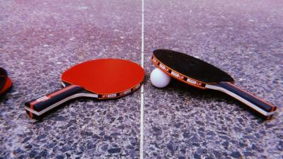 Tischtenniskellen liegen auf einer Tischtennisplatte (Bild vergrößern)