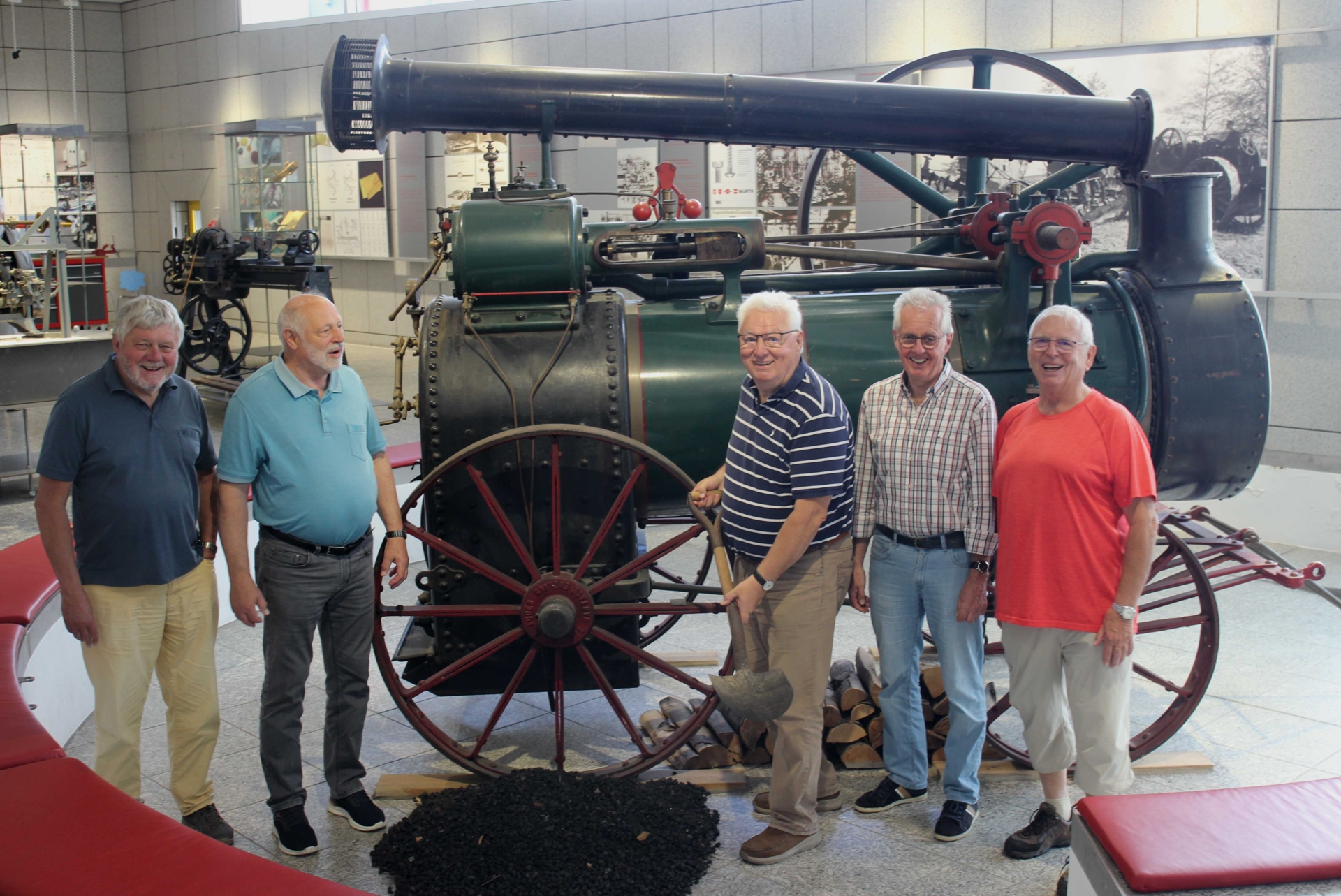 Ein Teil der TSV-Männer-Gymnastik-Gruppe aus Rodenbach vor dem Lokomobile (fahrbare Dampfmaschine) im Museum 1 Würth in Künzelsau