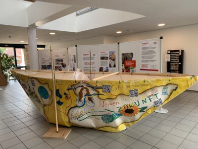 Im Bild die heute vorbereitete Ausstellung. Im Mittelpunkt steht ein unter Leitung der AWO Emsland in Meppen gestaltetes Boot. Dieses Boot erinnert an die tausendfachen auf den Meeren ertrunkenen Menschen. (Bild vergrößern)