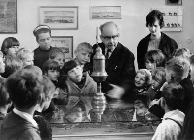 Albert Guthke erklärt einer Schulklasse einen Wandwerkspokal. Foto: Archiv Museum Pritzwalk (Bild vergr&ouml;&szlig;ern)