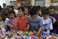 Schüler tauschen und handeln mit ihren Spielzeugen beim Spielzeugbasar