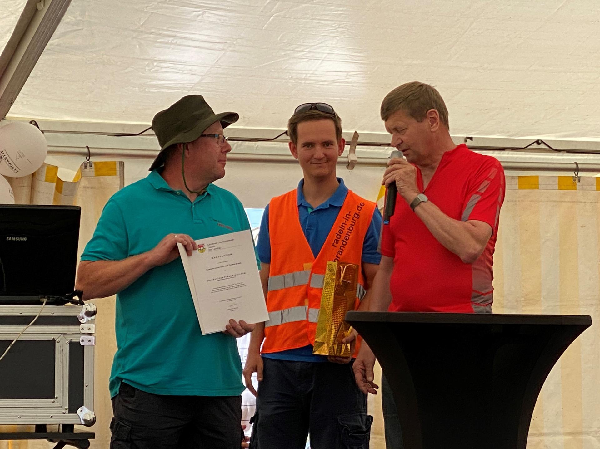 Auch Thomas Domin begrüßte die Teilnehmenden der Tour de OSL. Landrat Heinze beglückwünschte Ihn zum 25-jährigen Bestehen seines Betriebes. (Bild: Landkreis OSL/Nora Bielitz)