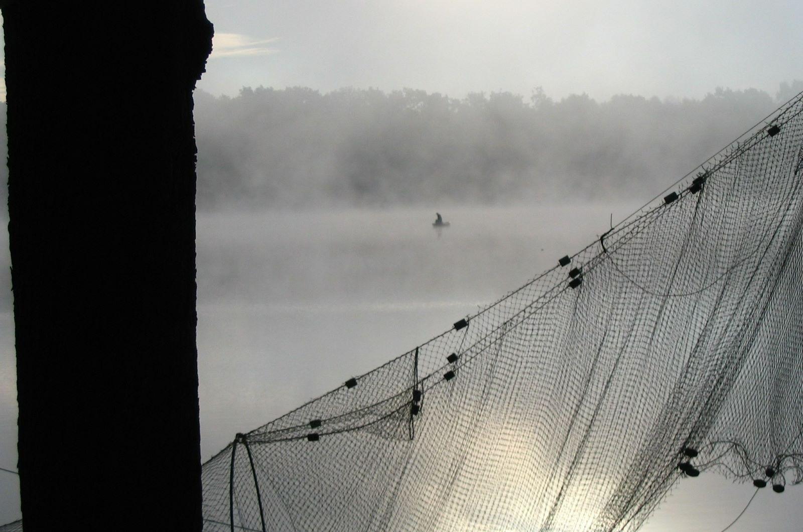 Fishing at misty dawn