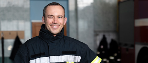 male-firefighter-posing-with-suit-helmet